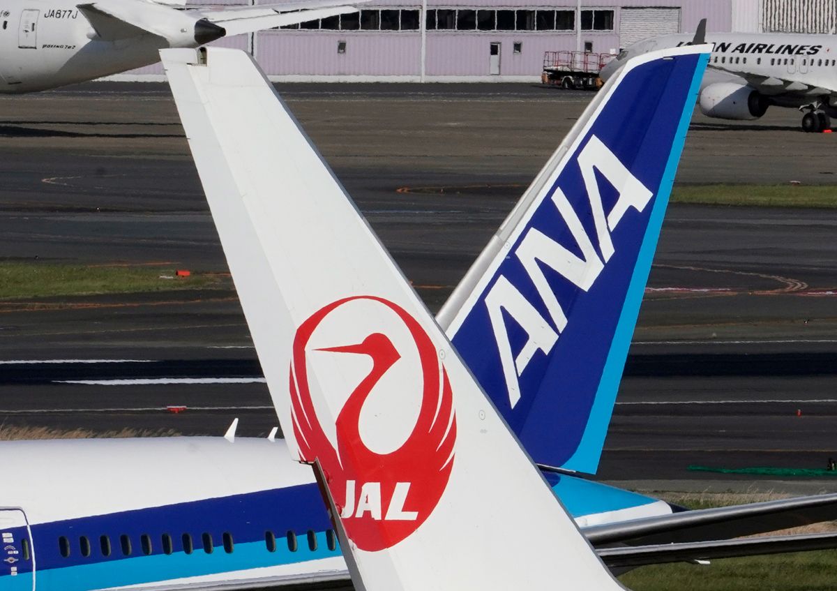 東京・羽田空港の滑走路に駐機する日本航空（ＪＡＬ）と全日本空輸（ＡＮＡ）の航空機（ＥＰＡ時事）
